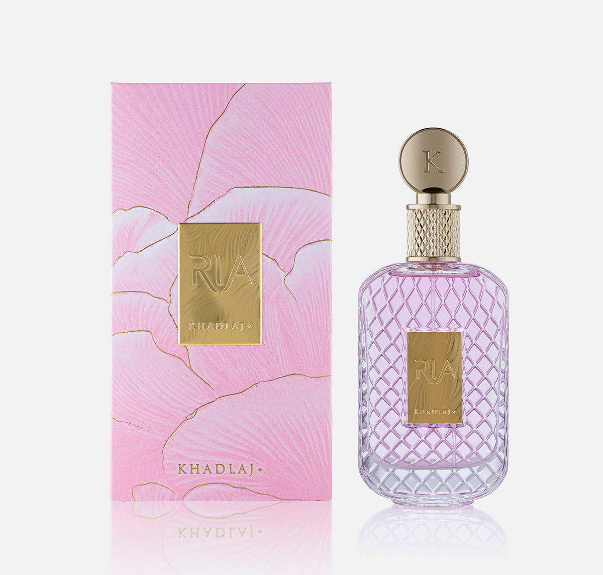 Khadlaj Ria Eau de Parfum 100ml bottle beside its pink marbled gift box with gold foil detailing